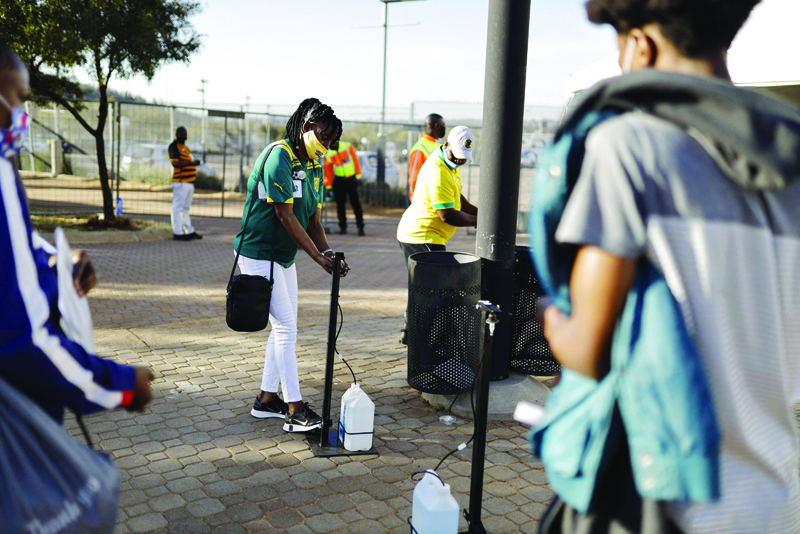 JOHANNESBURG: Supporters of the Bafana Bafana, the South African national soccer team, disinfects their hands as they arrive at the FNB Stadfium in Johannesburg. - AFP n