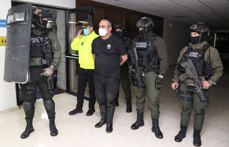 BOGOTA: Handout picture shows members of the Colombian Army escorting Colombia's most-wanted drug lord and head of the Gulf Clan, Dairo Antonio Usuga (center) -alias 'Otoniel'-, after his capture in Bogota. - AFP n