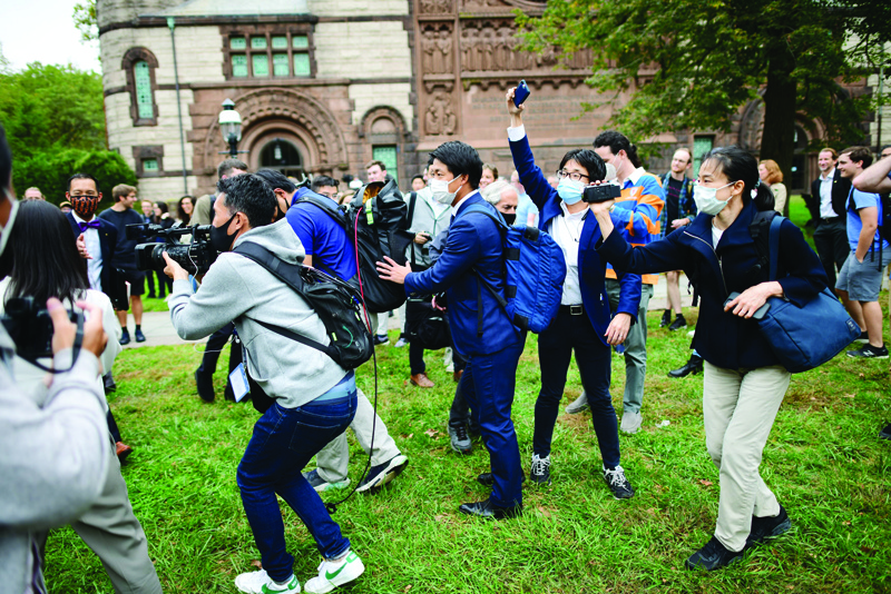 NEW JERSEY: Members of the Japanese media strain to film Princeton University senior meteorologist Syukuro Suki Manabe departing a press conference after he was awarded a share of the 2021 Nobel Prize in physics at Princeton University in Princeton, New Jersey. - AFP n