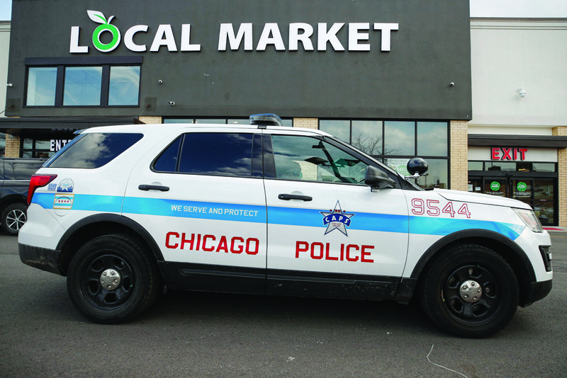 CHICAGO: In this file photo, a Chicago Police cruiser monitors the area outside the Local Market Foods store in Chicago, Illinois. Up to half of Chicago's police face being placed on unpaid leave after refusing to disclose their COVID-19 vaccine status, in a high-stakes game of chicken that comes as the US city grapples with a surge in violent crime. - AFPn