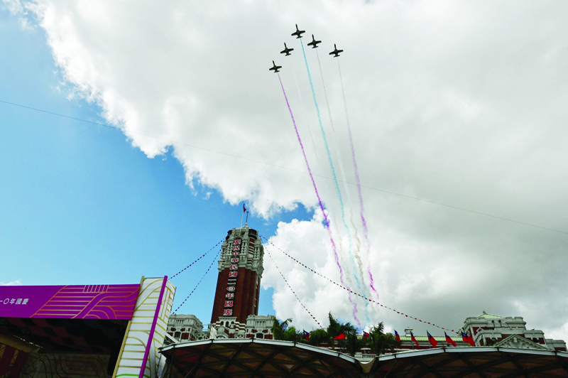 TAIPEI: Taiwanese Air Force AT-3 jets fly over the Presidential Palace during national day celebrations in Taipei on October 10, 2021. - AFP n