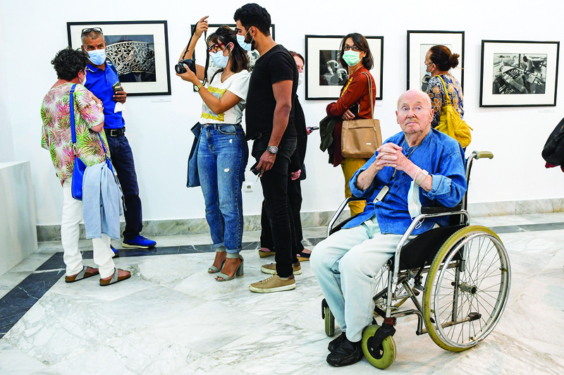 Tunisian photographer Jacques Perez (wheelchair) attends the launch of his exhibition “Memories before Oblivion” at Kheireddine (Hayreddin) Palace in the Medina of Tunisia’s capital Tunis.—AFP photosn