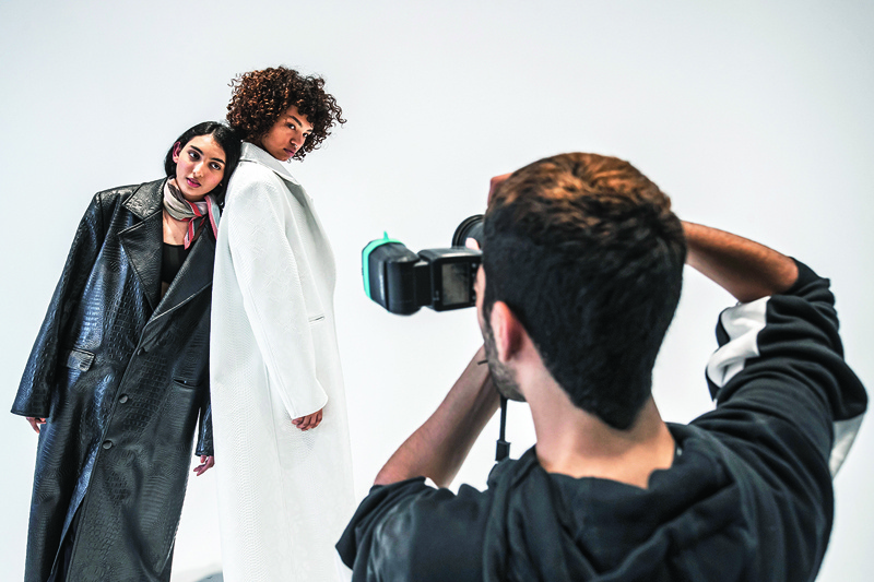 (From left to right) Egyptian fashion models Zeina Ehab and Mariam Abdallah pose during a photo session at the studio of UNN Model Management agency in Cairo. - AFP photosn