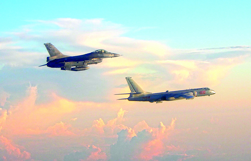 IN THE AIR: This file handout picture taken and released by Taiwanís Defense Ministry shows a Taiwan F-16 fighter (left) jet monitoring one of two Chinese H-6 bombers that flew over the Bashi Channel south of Taiwan and the Miyako Strait, near Japanís Okinawa Island. — AFP