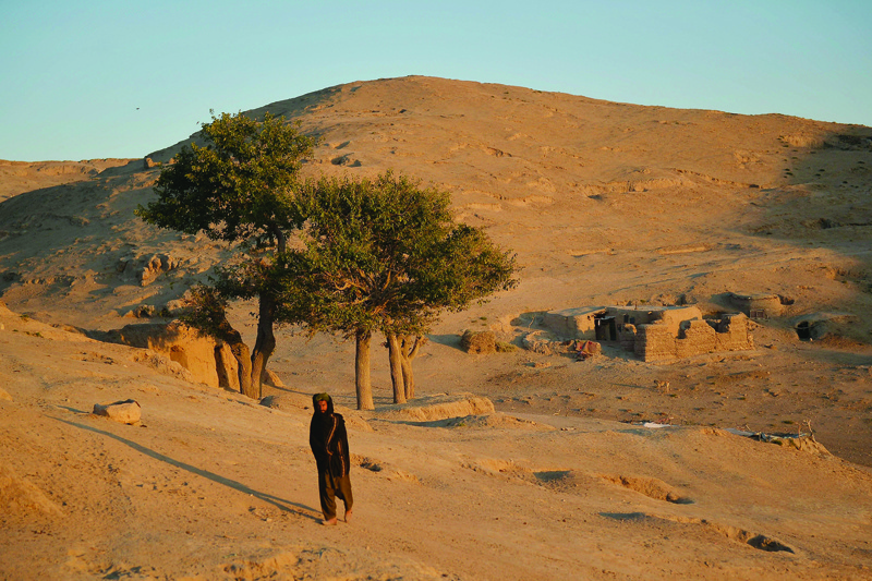 BALA MURGHAB: Photo shows a man walking as the sun sets at the Jamal Khan village of Bala Murghab district in Badghis province. Drought stalks the parched fields around the remote Afghan district of Bala Murghab, where climate change is proving a deadlier foe than the country's recent conflicts. - AFP n