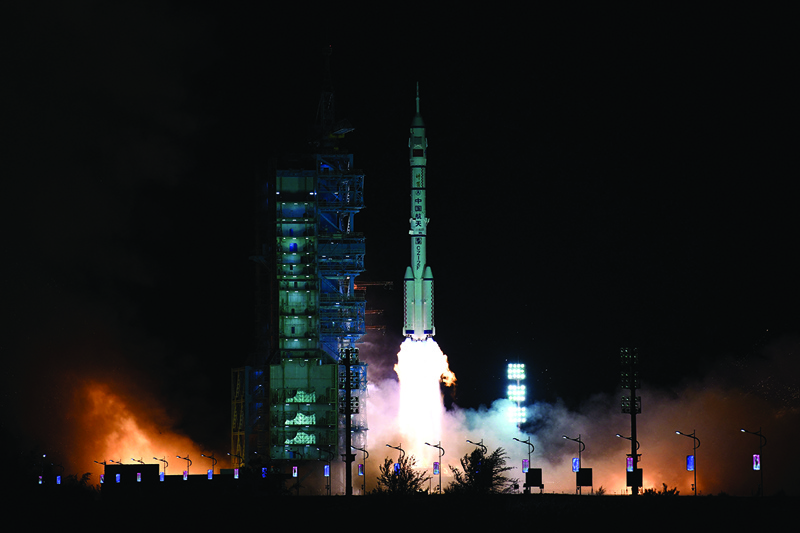 JIUQUAN: A Long March-2F carrier rocket, carrying the Shenzhou-13 spacecraft with the second crew of three astronauts to China’s new space station, lifts off from the Jiuquan Satellite Launch Centre in the Gobi desert in northwest China yesterday. – AFP n