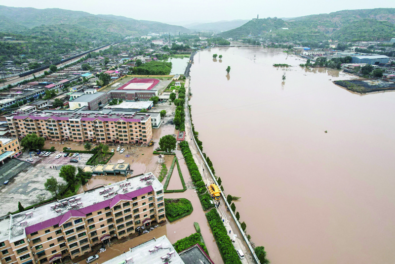 JINZHONG: This aerial photo shows a flooded area after heavy rainfalls in Jiexiu, in Jinzhong city, China's northern Shanxi province.  - AFP n