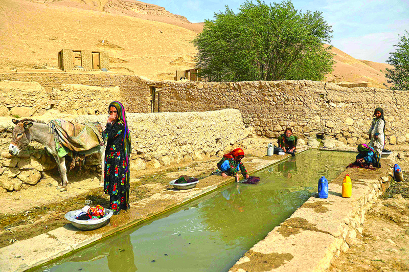 BALA MURGHAB: Children wash clothes in Bala Murghab district of Badghis province. Drought stalks the parched fields around the remote Afghan district of Bala Murghab, where climate change is proving a deadlier foe than the country’s recent conflicts. – AFP n