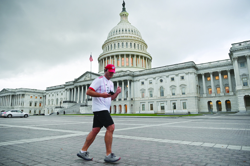 WASHINGTON, US: A person jogs past the US Capitol in Washington, DC. US lawmakers rubber-stamped a short-term bill to lift the nation's borrowing authority Tuesday, averting the threat of a first-ever debt default -- but only for a few weeks. - AFPnn