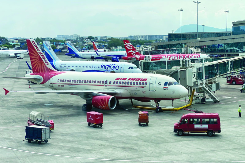 MUMBAI: An Air India aircraft is pictured at a terminal of the airport in Mumbai on Saturday as the Indian government has agreed to sell the heavily-indebted Air India to the Tata conglomerate for 180 billion rupees ($2.4 billion).—AFPnn