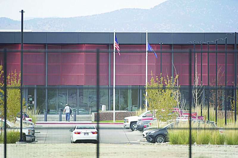 EAGLE MOUNTAIN: An employee walks into a newly completed data center in Eagle Mountain, Utah. Facebook was shut down yesterday for more than seven hours reportedly due in part to a major disruption in communication between the company's data centers. - AFP n