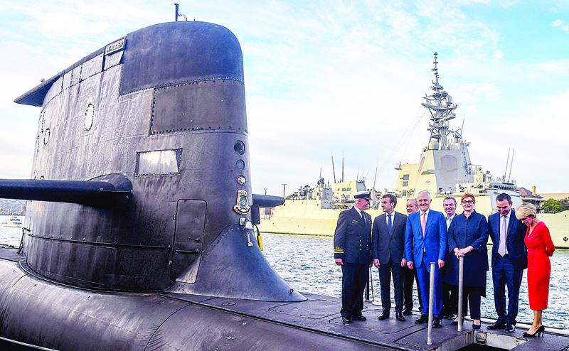 SYDNEY: A file photo shows French President Emmanuel Macron (2nd left) and Australian Prime Minister Malcolm Turnbull (center) standing on the deck of HMAS Waller, a Collins-class submarine operated by the Royal Australian Navy. - AFP n