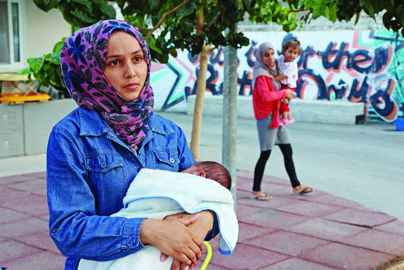 KOFINOU: Kawthar Raslan, 25-year-old Syrian refugee who reached Cyprus on boat while pregnant and was separated from the rest of her family, holds her baby Yazan at the Kofinou asylum centre near the Cypriot coastal city of Larnaca. - AFP n