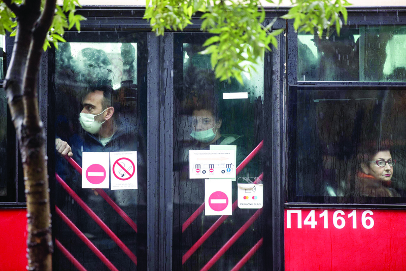 BELGRADE: People wearing protective face masks ride a bus in Belgrade amid the COVID-19 (novel coronavirus) pandemic. - AFP n