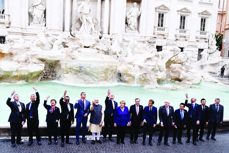 ROME: Leaders and senior officials throw coins in the water during a visit to the Trevi fountain yesterday on the sidelines of the G20 Leaders' Summit. - AFP n