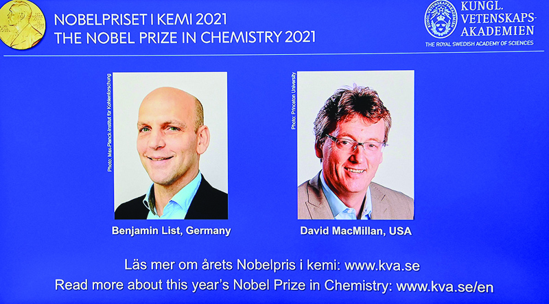 STOCKHOLM: A screen displays the co-winners of the 2021 Nobel Prize in Chemistry, Germany's Benjamin List (left) and David MacMillan of the US, during a press conference at the Royal Swedish Academy of Sciences yesterday. - AFP n