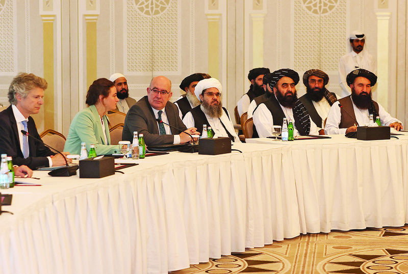 DOHA: Foreign diplomats and a Taleban delegation meet yesterday. - AFP n