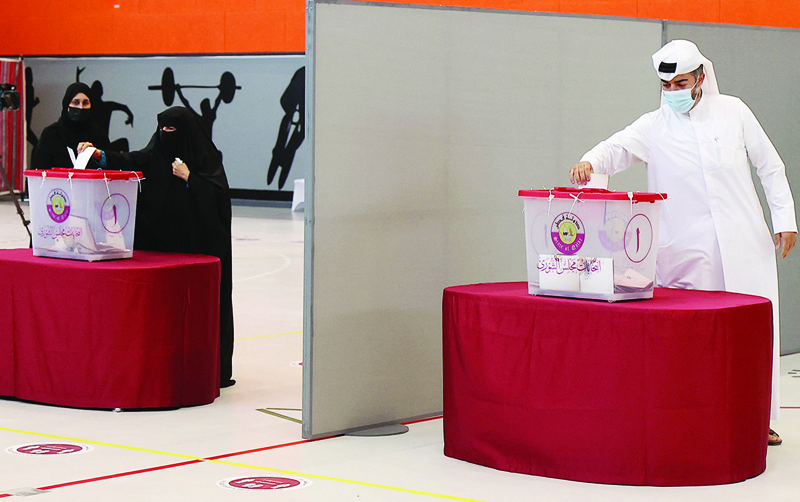 DOHA: Qataris cast their ballots at a polling station yesterday, during the country's first ever legislative vote. - AFP n
