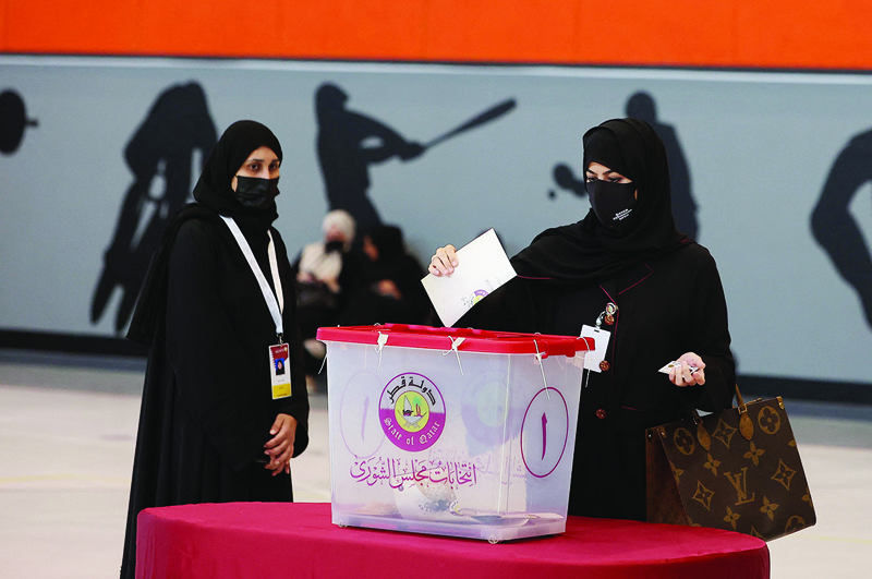 DOHA: A Qatari woman casts her ballot at a polling station on Sunday, during the country's first ever legislative vote. - AFP n