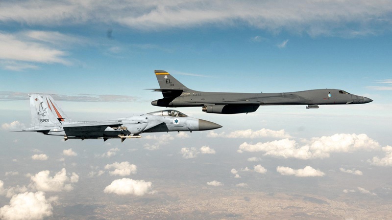 A Zionist F-15 fighter (left) escorts an American B-1 heavy bomber on Saturday. - AFP n