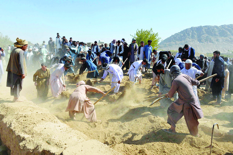 KANDAHAR: Victims of a suicide bomb attack at a Shiite mosque are buried at a graveyard yesterday. - AFP n