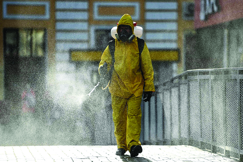 MOSCOW: A serviceman of Russia's emergencies ministry disinfects Moscow's Savelovsky railway station yesterday amid the ongoing coronavirus pandemic. - AFP n