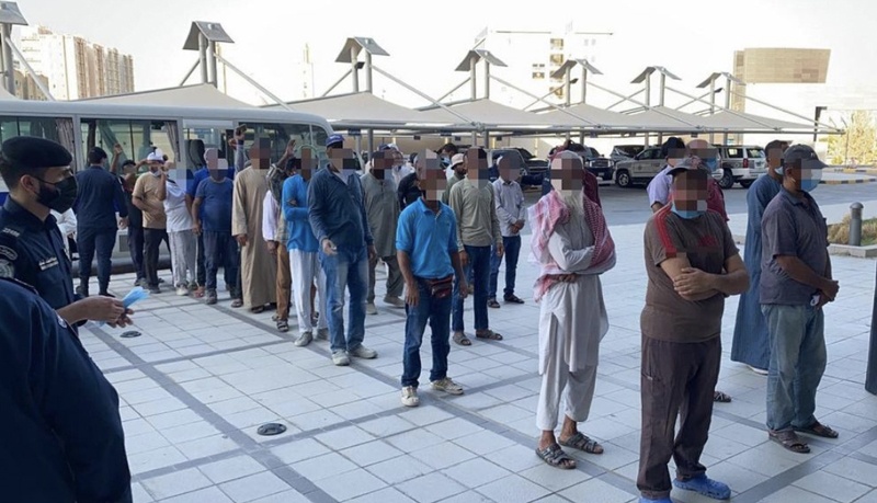 KUWAIT: People are lined up during a police crackdown in Jahra on Sept 30, 2021 against violators of labor and residency laws. - MoI nn