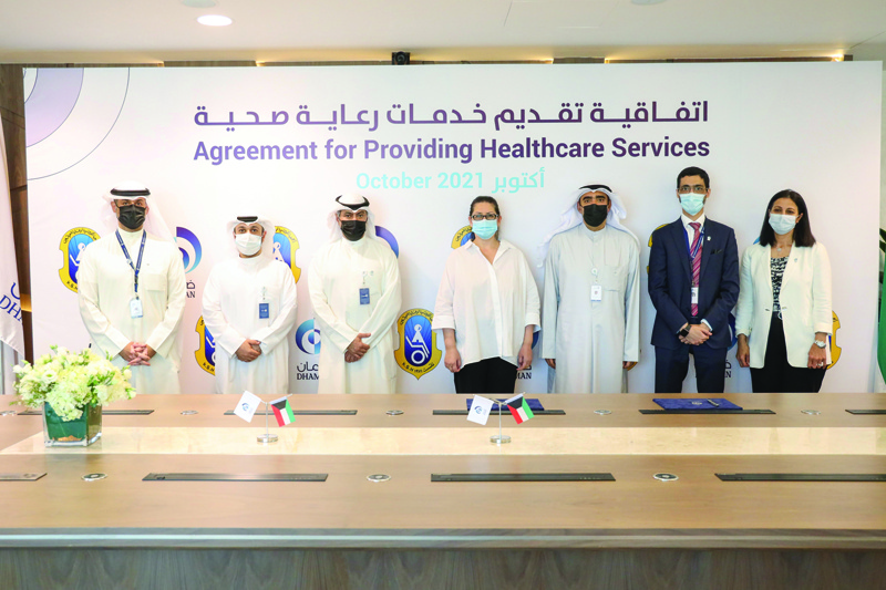 KUWAIT: Health Assurance Hospitals Company (DHAMAN) and Kuwait Society for the Handicapped (KSH) officials pose for a group photo during the signing ceremony.n