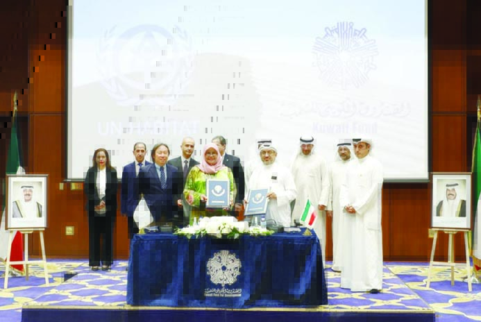 KUWAIT: United Nations Under-Secretary-General and Executive Director of the Program Maimunah Sharif (left) and KFAED Director-General Marwan Al-Ghanem pose for a group picture after signing the agreement. - KUNA photosn