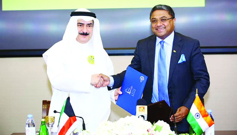 KUWAIT: NCCAL Secretary General Kamel Abdul Jalil and Indian Ambassador to Kuwait Sibi George shake hands after signing a cultural agreement at Kuwait National Library yesterday. - Photos by Yasser Al-Zayyat nn