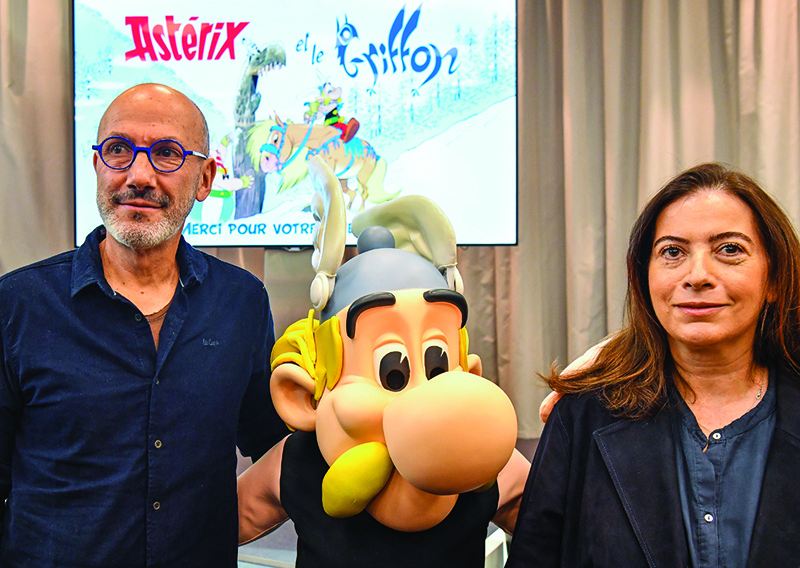 French writer and designer Jean-Yves Ferri poses with French writer Anne Goscinny (right), daughter of late Rene Goscinny, during the presentation of the new “Asterix” album at the Hachette Livre publishing house in Vanves, near Paris.—AFP n