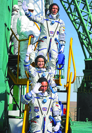Cosmonaut Anton Shkaplerov (bottom), actress Yulia Peresild (center) and film director Klim Shipenko (top) react during boarding Russia's Soyuz MS-19 spacecraft before blasting off to the ISS from the launch pad at the Russian-leased Baikonur cosmodrome in Kazakhstan. - AFP photosn