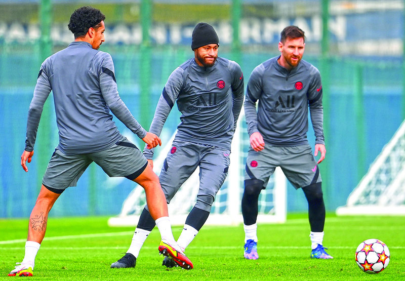 SAINT-GERMAIN-EN-LAYE: Paris Saint-Germain's forward Neymar (center) controls the ball next to forward Lionel Messi (right) and defender Marquinhos during a training session at the club's Camp des Loges training ground in Saint-Germain-en-Laye yesterday, on the eve of their UEFA Champions League first round group A football match against RB Leipzig. – AFPnn