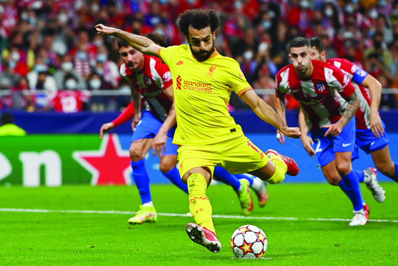 MADRID: Liverpool's Egyptian forward Mohamed Salah shoots and scores a penalty kick during the UEFA Champions League Group B football match between Atletico Madrid and Liverpool at the Wanda Metropolitano stadium in Madrid on Tuesday. - AFPn