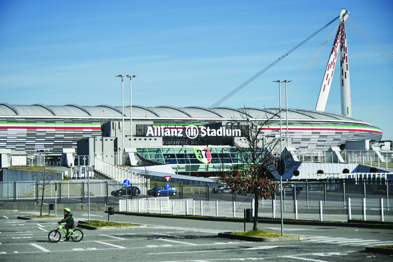 TURIN: In this file photo taken on March 10, 2020 A general view shows a boy cycling across a deserted area by the Juventus stadium in Turin. - AFPn