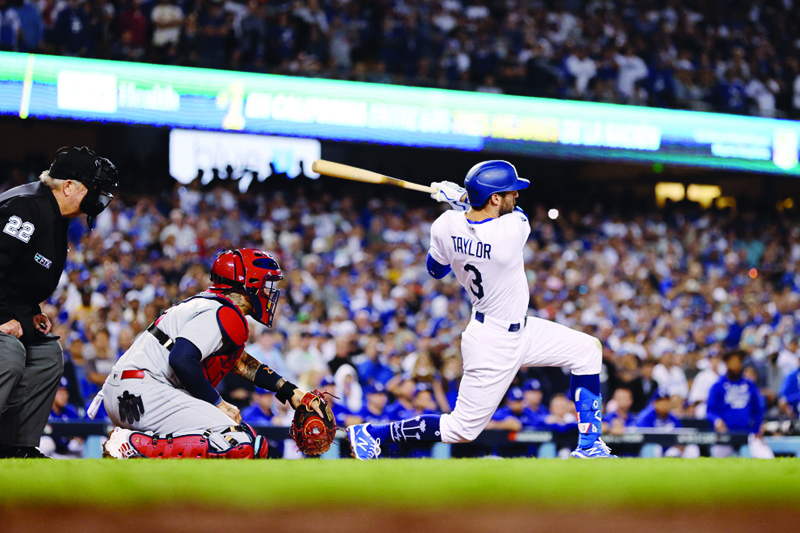 LOS ANGELES: Chris Taylor #3 of the Los Angeles Dodgers hits a walk off two-run home run in the ninth inning to defeat the St Louis Cardinals 3 to 1 during the National League Wild Card Game at Dodger Stadium on Wednesday. - AFP n
