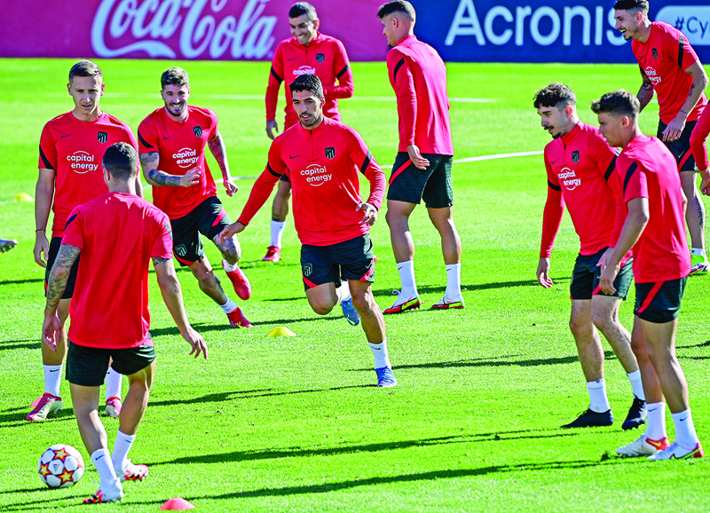 MADRID: Atletico Madrid's Uruguayan forward Luis Suarez (center) and teammates take part in a training session in Madrid yesterday, on the eve of their UEFA Champions League first round group B football match against Liverpool.  – AFPn