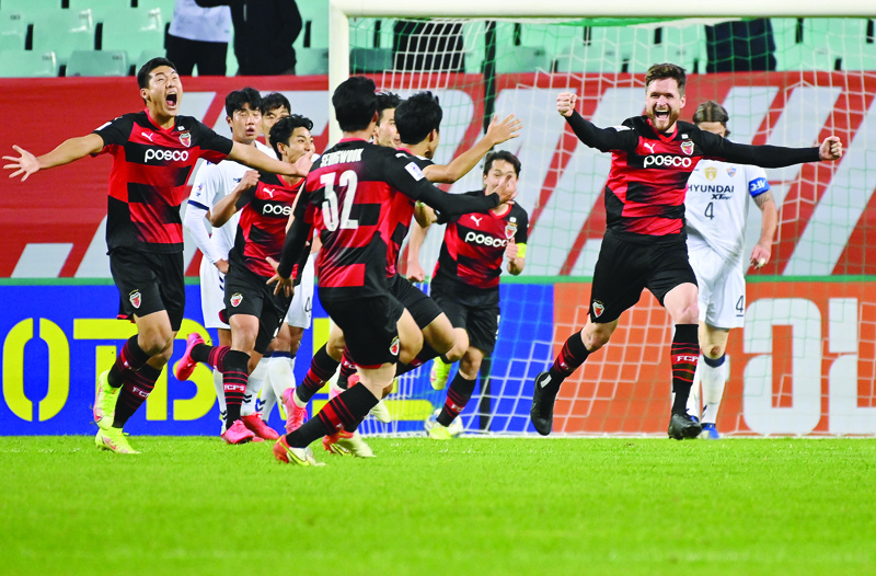 JEONJU: Pohang Steelers' Alex Grant (right) celebrates his goal with teammates against Ulsan Hyundai during the AFC Champions League semi-finals football match between South Korea's Ulsan Hyundai FC and FC Pohang Steelers in Jeonju yesterday. - AFPn