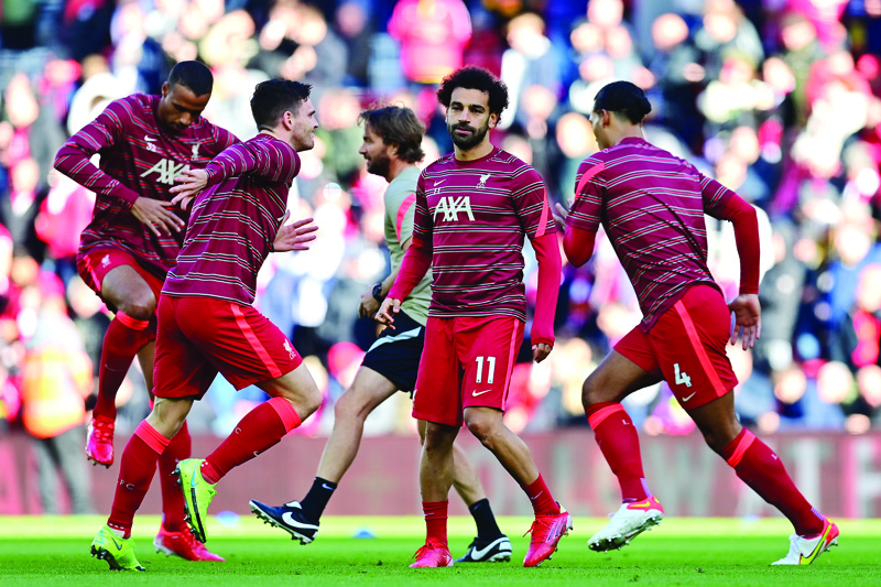 LIVERPOOL: Liverpool's Egyptian midfielder Mohamed Salah (center) warms up with teammates before their English Premier League football match against Manchester City at Anfield in Liverpool, northwest England, on Sunday. - AFPn