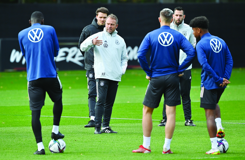 HAMBURG: Germany's head coach Hans-Dieter Flick (center) overseas a training session yesterday Hamburg, northern Germany, before their football 2022 World Cup qualifier 1st round group J match Germany v Romania scheduled tomorrow. - AFPn