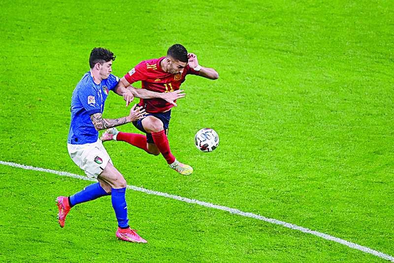 MILAN: Italy's defender Alessandro Bastoni (left) fights for the ball with Spain's forward Ferran Torres during the UEFA Nations League semifinal football match at the San Siro stadium on Wednesday. - AFP n