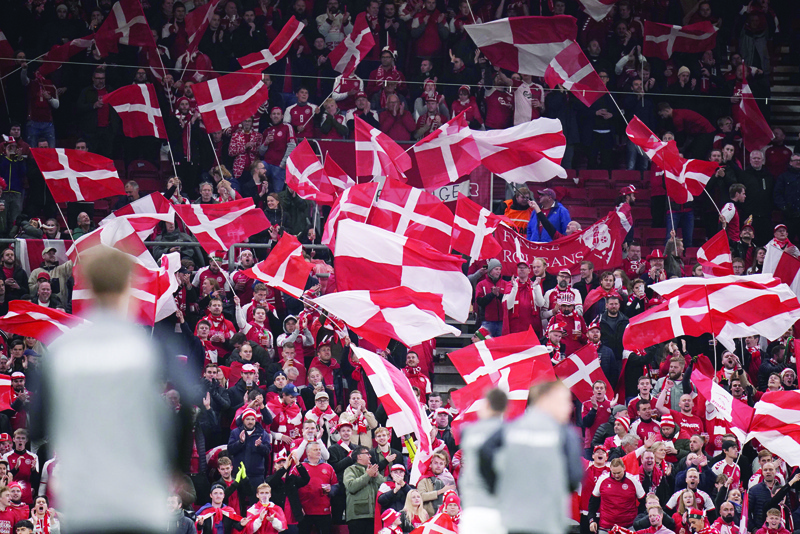 COPENHAGEN: Dnish fans cheer during the FIFA World Cup Quatar 2022 qualification Group F football match between Denmark and Austria in Copenhagen on Tuesday. - AFPn