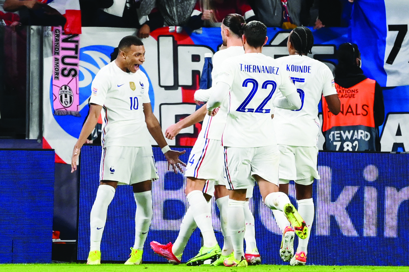 TURIN: France's forward Kylian Mbappe (left) celebrates with teammates after scoring a goal during the UEFA Nations League semi-final football match between Belgium and France at the Juventus stadium in Turin, on Thursday. - AFPn