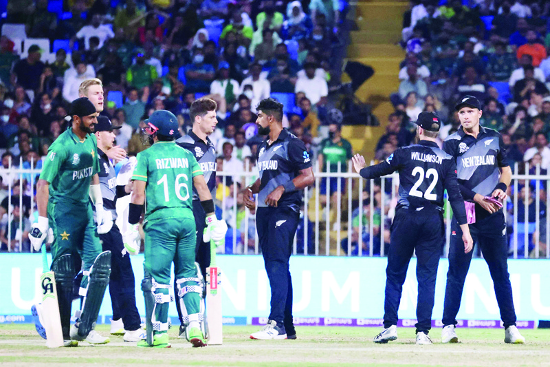 SHARJAH: New Zealand's cricketers celebrate the dismissal of Pakistan's Mohammad Rizwan (front second left) during the ICC men's Twenty20 World Cup cricket match at the Sharjah Cricket Stadium yesterday. - AFP n
