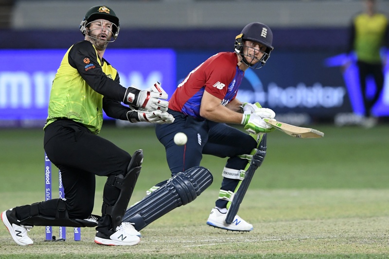 DUBAI: England's Jos Buttler plays a shot as Australia's wicketkeeper Matthew Wade watches during the ICC men's Twenty20 World Cup cricket match at the Dubai International Cricket Stadium yesterday. - AFP n