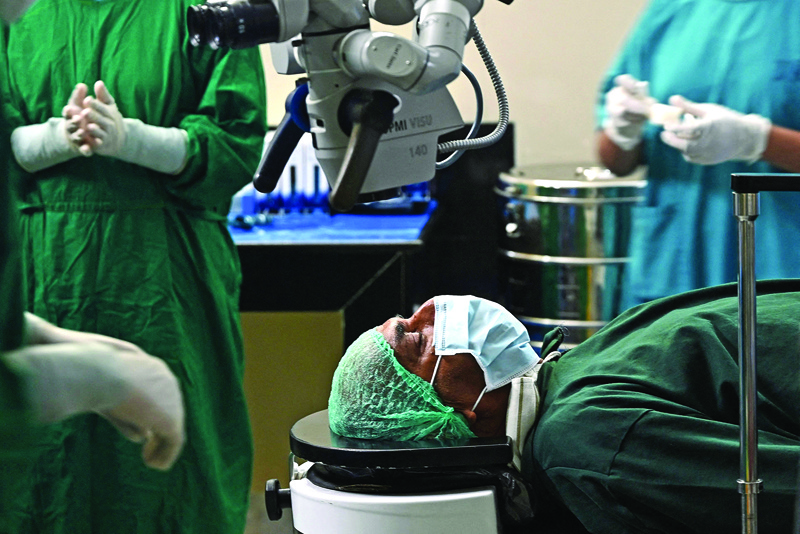 MADURAI: Medical staff prepares to conduct a free cataract eye surgery on patient Venkatachalam Rajangam at Aravind eye hospital in Madurai in India's Tamil Nadu state. - AFP nnnnn