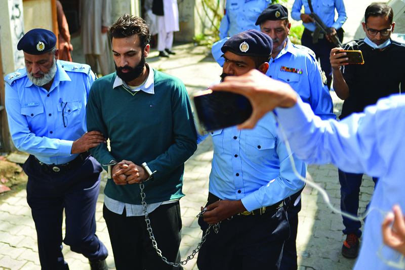 ISLAMABAD: Policemen escort Zahir Jaffer (2nd left), a Pakistani-American man who went on trial accused of raping and beheading his girlfriend - the daughter of a former ambassador, after his court hearing in Islamabad yesterday. – AFP n