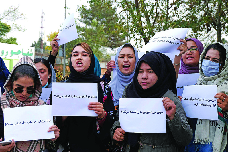 KABUL: Women hold placards during a protest in Kabul - calling for the international community to speak out in support of Afghans living under Taleban rule.- AFP n