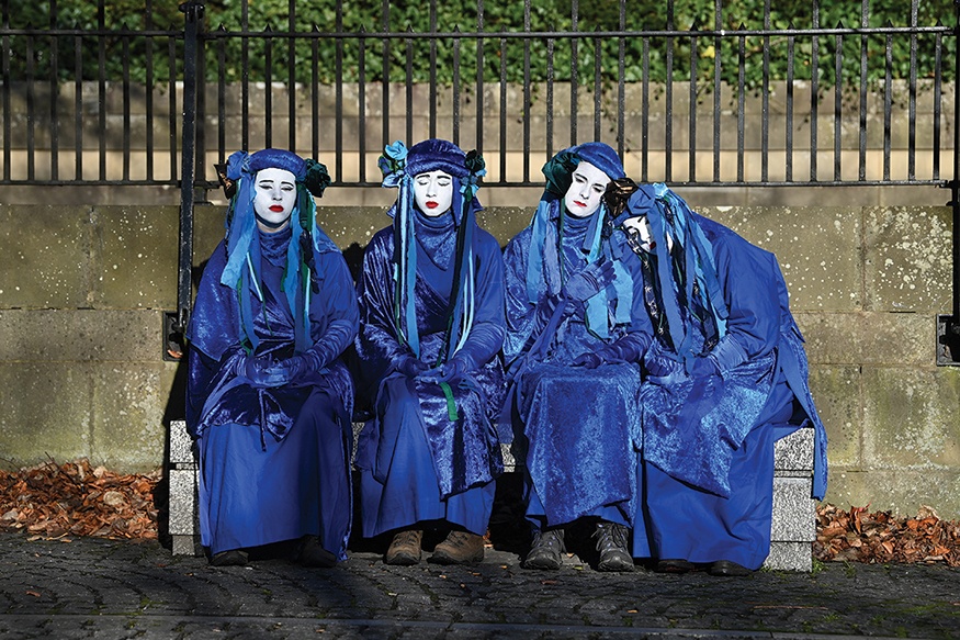 GLASGOW: Performers of the Blue Rebels prepare to conduct a funeral ceremony to symbolize the failure of the COP26 process, at Glasgow Cathedral in Glasgow yesterday during the COP26 UN Climate Change Conference. — AFP