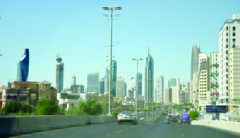 KUWAIT: Vehicles drive on Istiqlal Road as Kuwait City's high-rise building are seen. - Photo by Fouad Al-Shaikhn